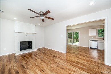Living room with view of WBFP and kitchen