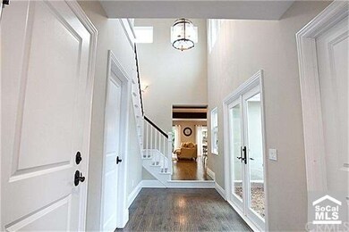 The entry has an open feel with high ceilings lead