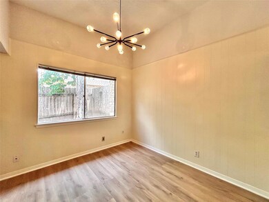Unfurnished room with a chandelier, wood finished