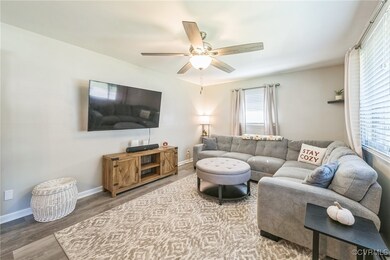 Living room with wood-type flooring and ceiling fa