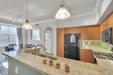 Kitchen with light stone counters, tasteful backs