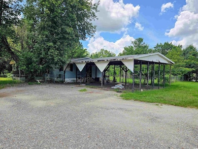 View of front of home featuring driveway and a carport