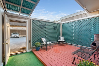 view of back patio leading to parking