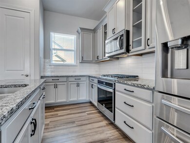 Bright kitchen with granite counters and upgraded fixtures