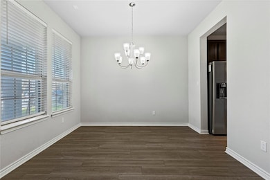 Unfurnished dining area featuring a chandelier, d