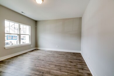 Large window looks out on the front porch of home (finishes will differ)