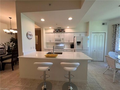 Kitchen with white cabinetry, sink, stainless stee