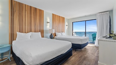Bedroom featuring wood finished floors and access to outside