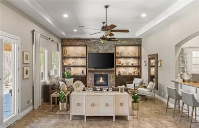 Living room featuring crown molding, a ceiling fan