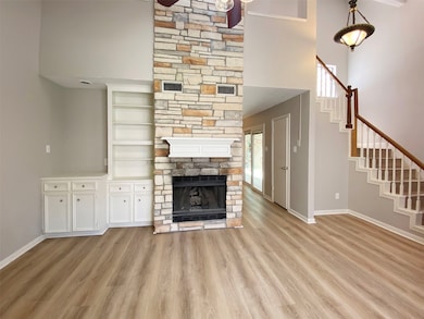 Stacked stone fireplace with gas logs.