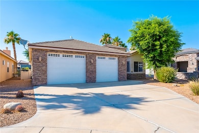 View of front of home with a tile roof, a garage,