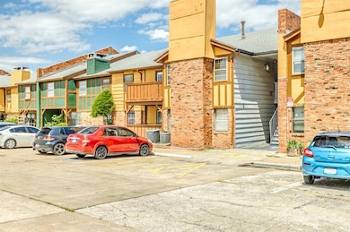 View of property with uncovered parking, cooling unit, and a residential view