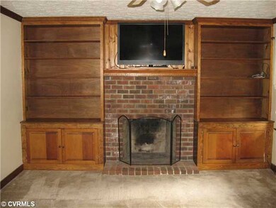 Living Room - Wood Burning Fireplace and Built In Cabinetry.