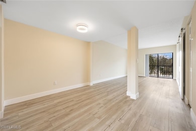 Spare room with baseboards and light wood-type flo