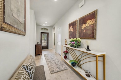 Make your way through the inviting entryway and into the stunning open-concept living space.