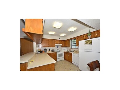Eat in kitchen is fully equipped with lots of cabinet and lighting.
