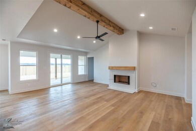 Unfurnished living room with ceiling fan, lofted c