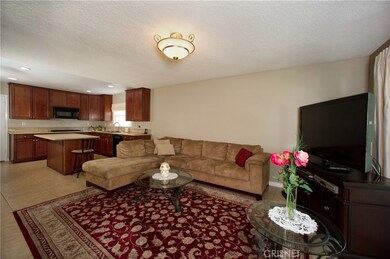 Large family room adjacent kitchen and opens to backyard through sliding glass doors