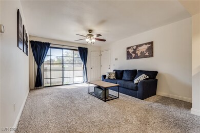 Living area featuring carpet, a ceiling fan, and b