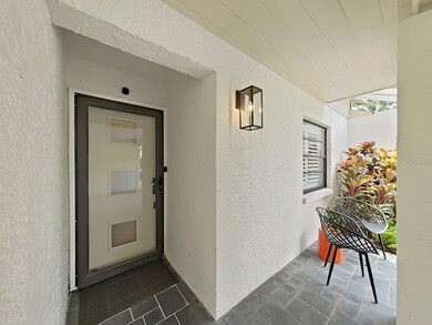 Covered front porch & door with full-view glass storm door.