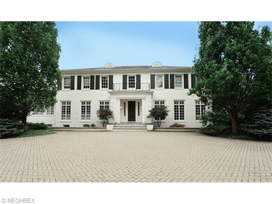 Elegant paver driveway leads up to this stately ho