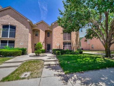 View of front of property with a front yard and brick siding