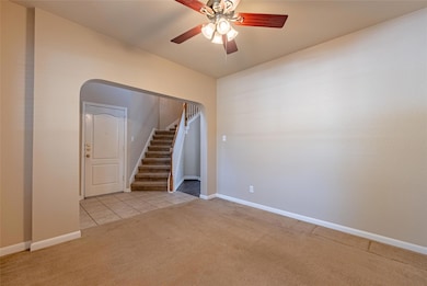 Carpeted spare room featuring stairway, ceiling f