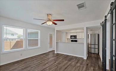 Kitchen featuring freestanding refrigerator, a ba