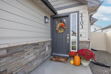 Doorway to property featuring stone siding