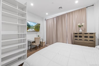 Bedroom featuring dark wood-style floors and recessed lighting