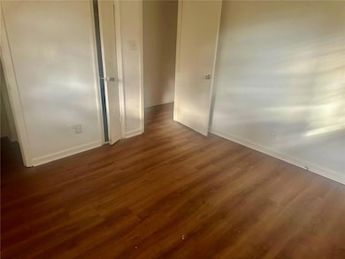 Unfurnished room with dark wood-type flooring