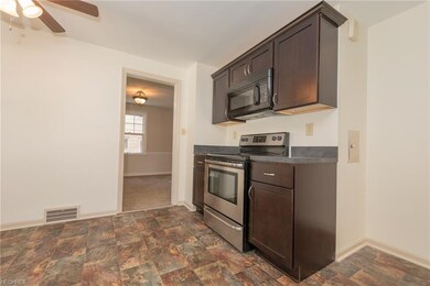 This delightful Kitchen has beautiful dark wood ca