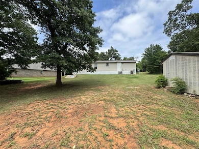 View of grassy yard with an outdoor structure