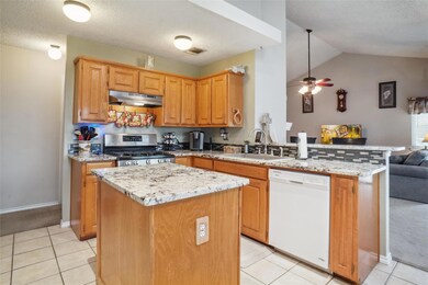 Kitchen with new granite countertops and island.