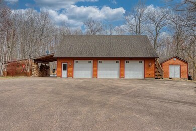 Detached garage featuring a shed