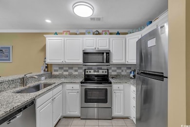 Kitchen featuring visible vents, a sink, backsplash, stainless steel appliances, and light tile patterned floors