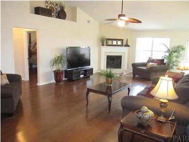 Great room with HARDWOOD floors. Entrance to the master suite to your left. The corner gas fireplace gives the room a cozy feel!