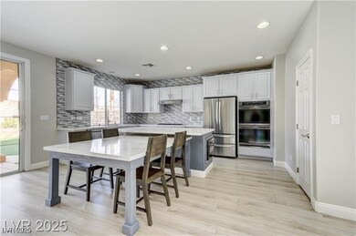 Kitchen featuring backsplash, light countertops, a