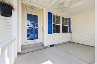 Doorway to property featuring ceiling fan and a porch