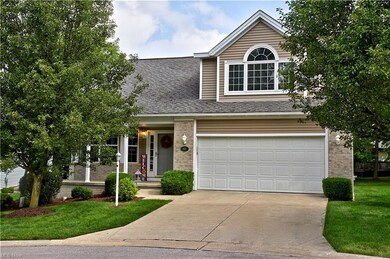 View of front of property with garage and a front lawn