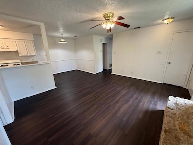 Unfurnished living room featuring dark wood-style