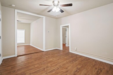 Spare room with ceiling fan and wood-type flooring