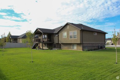 Rear view of property with stairs, stucco siding, a deck, brick siding, and a patio area