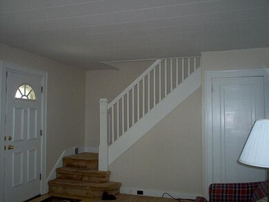 Living Room. Beautiful wood staircase.