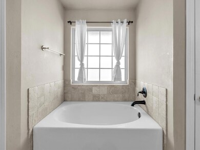 Bathroom featuring a tub and plenty of natural lig