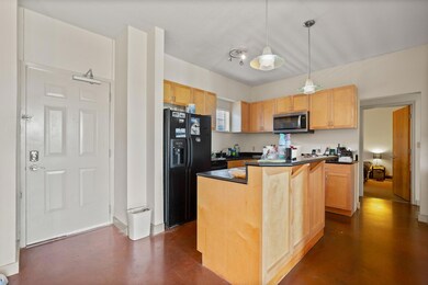 Kitchen featuring stainless steel microwave, blac