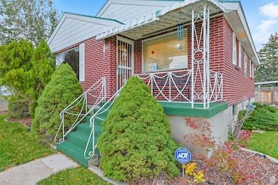 Property entrance with brick siding and covered porch