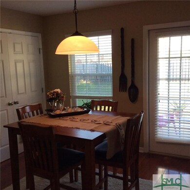 Dining area has hardwood flooring and door leading