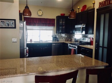 Kitchen has a Breakfast Bar, Granite Counters, Cus