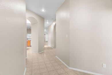 Corridor featuring light tile patterned flooring